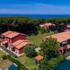Complesso di edifici rossi con tetti a tegola, vicino al mare.